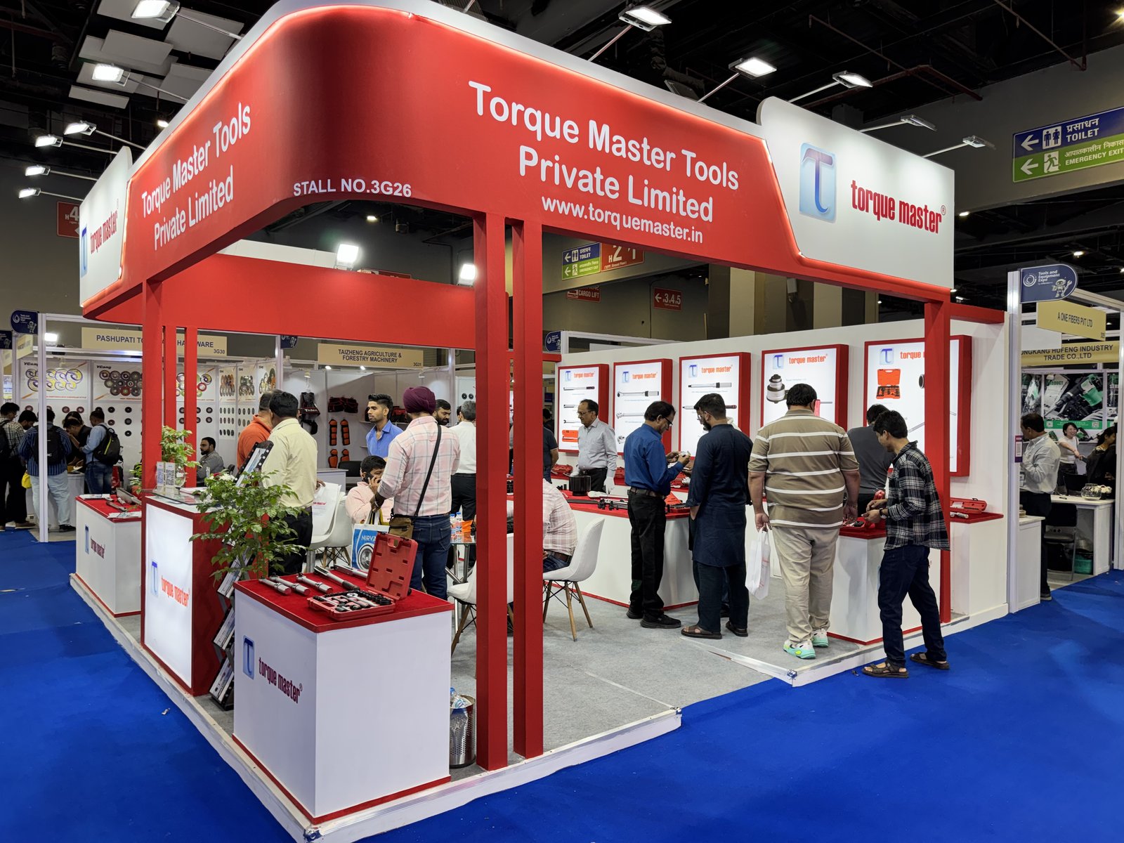 Front of the Torque Master Tools Private Limited stall 3G26 at an expo in Delhi, 2026, with www.torquemaster.in signage, display counters and visitors